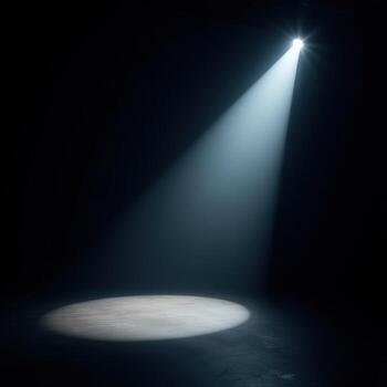 White spotlight focused on bare floor in dark empty space with soft ambient light photo