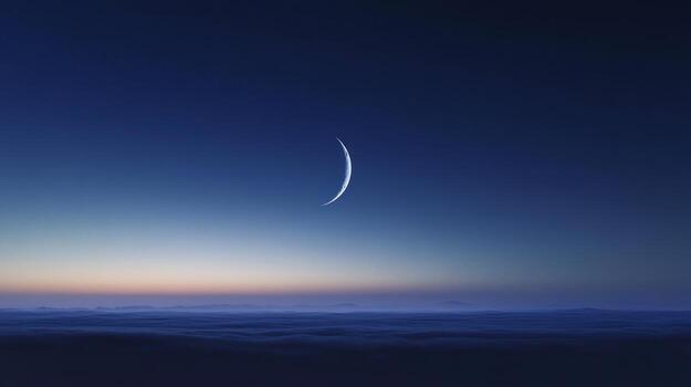 A slender crescent moon hangs in a deep twilight sky above a boundless expanse of low-lying clouds, creating a serene and ethereal landscape photo
