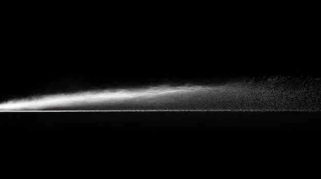 A stream of white particles emanating from a flat surface against a black backdrop photo