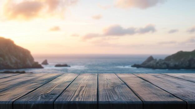 Rustic wooden table overlooking a tranquil ocean sunset photo