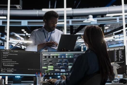 Computer scientist in data center using PC to visualize artificial intelligence neural networks made up of interconnected nodes. Server farm employee oversees AI systems processing information photo