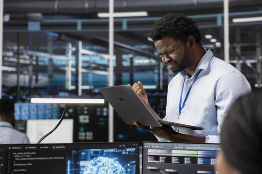 Angry engineer in data center annoyed by errors affecting equipment while using artificial intelligence computerized model. Irked server room employee frustrated by broken AI deep learning algorithms photo