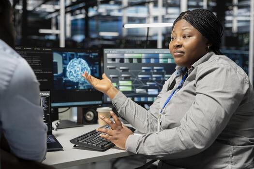 Server room engineering team doing brainstorming, using artificial intelligence to reduce downtime. Teamworking colleagues design and implement AI driven solutions for data center equipment photo