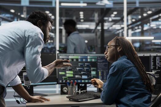 Data center software developers programming equipment used for machine learning training. Server room IT specialists talking, running code on PC to upgrade artificial intelligence systems photo