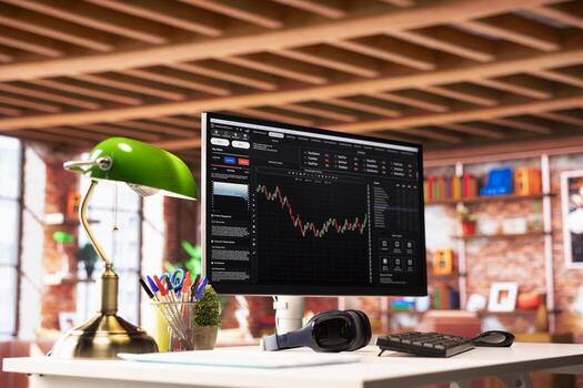 PC monitor in apartment showing day trading software interface used to purchase and sell stocks, close up. Application on computer screen showing investing stock exchange graphs photo