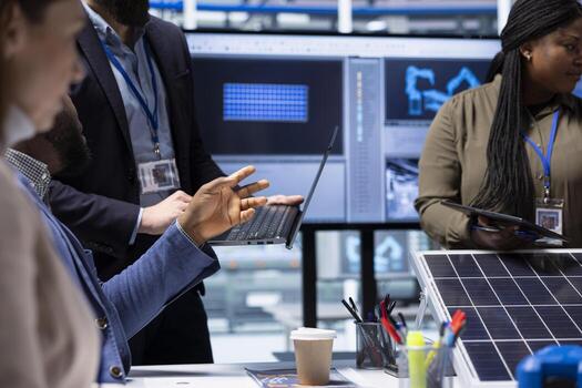 Photovoltaics factory engineer meeting with investors using laptop to highlight key elements of solar panel design. Manager using notebook to do presentation of industrial energy solutions, close up photo
