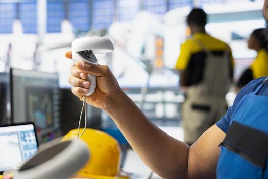 Black employee in solar panel facility uses virtual reality tech for troubleshooting and fixing technical errors within the photovoltaic systems. Male plant worker using VR headset for inspection. photo