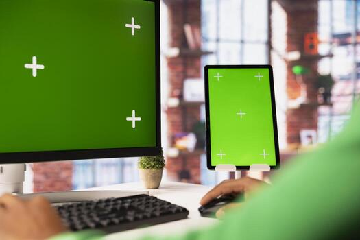 Person using green screen PC in home office to write emails. Remote employee typing on mockup computer keyboard, composing documents in order to deliver finalized project paperwork photo