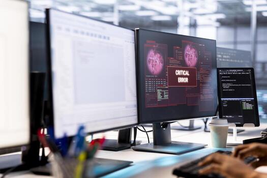 System administrator in server farm fighting hacker managing to pass firewall and stealing data. Worker receiving critical error notification on PC display in data center workspace photo