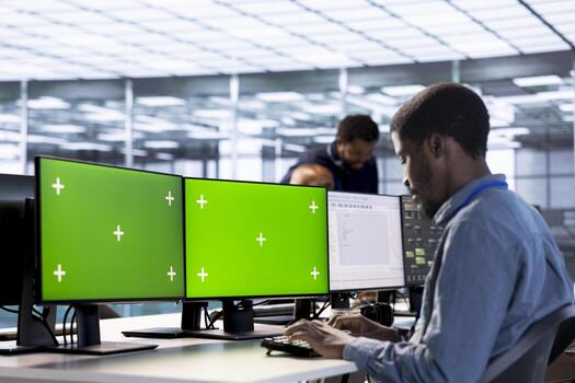 Server hub admin using isolated screen computer to find firewall misconfigurations. Employee checking systems bottlenecks leading to sluggish data transfer rates using multi monitor mockup PC photo