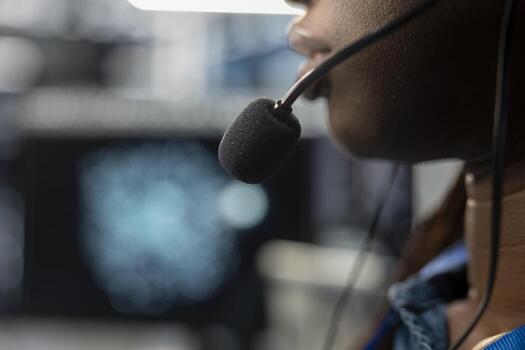 Close up of data center operator assisting project teams with complex installations, issuing commands though headset mic. Server farm specialist communicating with engineers in remote call photo