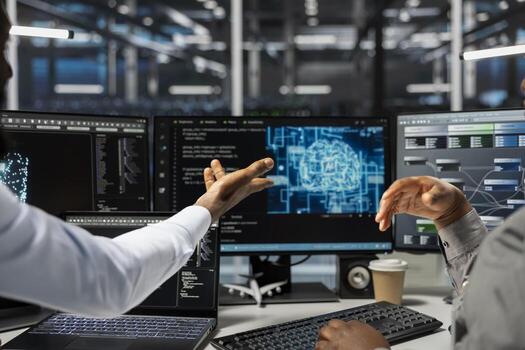 Data center technicians brainstorming, working together in office, using artificial intelligence computerized model. Server room coworkers collaborating, working with AI machine learning algorithms photo