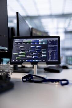 Tablet in data center providing computing resources for artificial intelligence processing massive datasets for training. Close up of code lines on device in server room used for machine learning photo