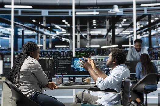 Data center technician and african american man with paraplegia visualize artificial intelligence neural networks. Person with disability and coworker in inclusive server hub overseeing AI systems photo