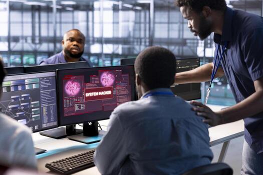 Team of computer scientists in server hub working together to protect equipment from hacker. IT coworkers in data center facility collaborating to fix security breach alert photo