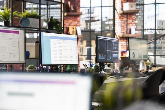 CSM system interfaces on computer monitors in empty customer service workplace used for logging customer interactions. Customer service management software UI on PC displays in call center photo