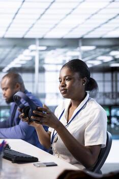 Woman in data center putting headphones on while using programming languages to construct applications. Server hub employee listening podcasts to make time pass faster while debugging code photo