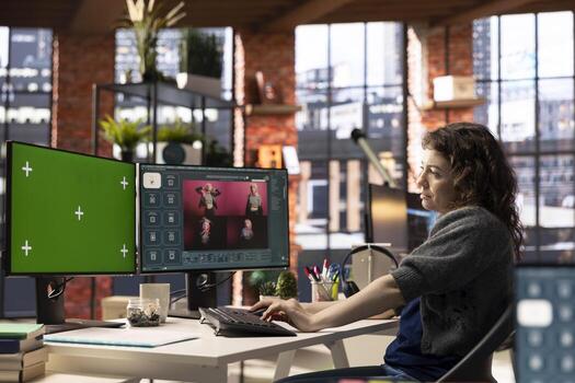 Focused woman using AI chatbot software and copy space display, turning text prompt into photos for a creative project. Young photographer uses text to image generative models on PC.