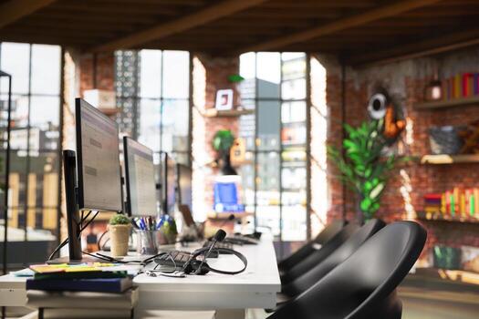 Empty call center office where unsatisfied customers call to solve technical problems. Empty customer support workspace computer monitors used for handling clients complaints photo