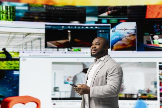 Man looks at videowall showcasing endless streaming channels and social media clips. User watching gaming clips, cooking tutorials and live broadcasts illustrating boundless content choice photo