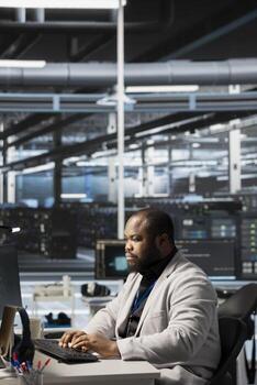 Data center system administrator analyzing software logs metrics on PC, optimizing storage systems. Server farm IT expert inspecting resource utilization on computer, managing application efficiency photo