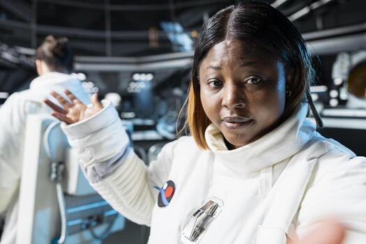 Astronaut participates in educational broadcast to inspire future space explorers. Spaceship crew member presenting life aboard orbiting science station to audiences back on Earth photo