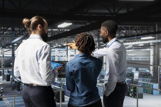 Data center staff on industrial platform collaborating to maintain servers using artificial intelligence. Engineers doing teamwork to support infrastructure AI deep learning automatization. photo