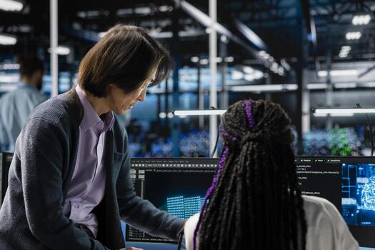 Mentor teaching intern in data center to install upgraded server racks systems with AI. Server room supervisor guiding trainee, upgrading gear using artificial intelligence photo