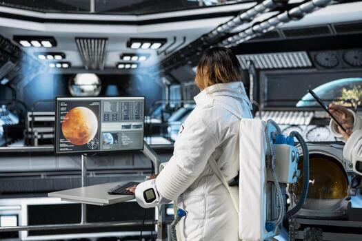 Astronaut in orbital station reviewing Mars planetary analytics on monitor. Spaceship crew member running telemetry software, doing Martian surface research to assist future planetary exploration photo