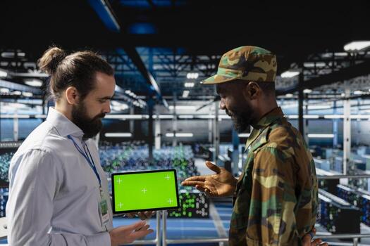 Army control center engineering team using chroma key copy space on tablet, working on national defense mission on industrial platform in control room base. Defend networks against threats. photo