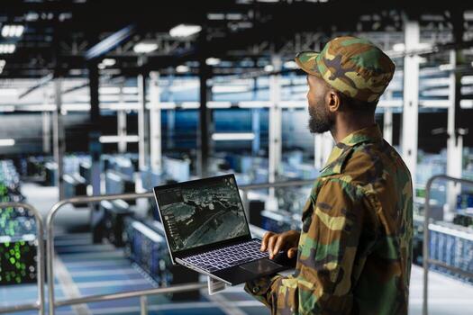 Army IT specialist in data center defending government networks against cyber threats. Military command center admin using AI to identify potential intrusions or malicious activity, anti terrorism. photo