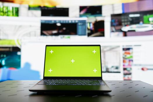 Close up of green screen laptop and VOD entertainment channels collage. Chroma key notebook in front of virtual background displaying social network feed activity digital dashboard photo