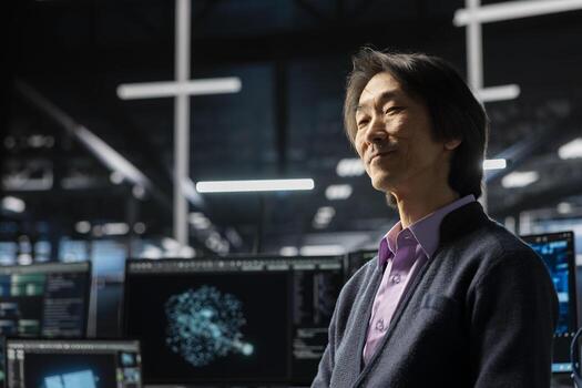 Happy engineer in data center using deep learning LLM assistant to do maintenance on gear rigs. Smiling Asian man in server hub using large language model chatbot to do backups photo