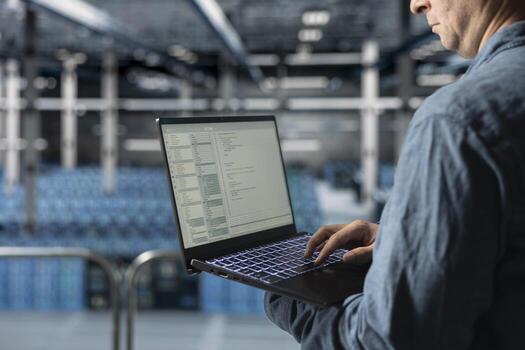 Close up of data center software developer analyzing supercomputers performance, resolving hardware bugs. Server farm IT specialist doing job tasks, coding, doing automatizations photo