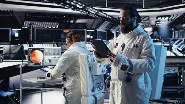 Astronaut conducting safety checks before stepping out for scheduled operations outside space station. Cosmonaut checks gear diagnostics on device, preparing to leave after landing on Mars photo