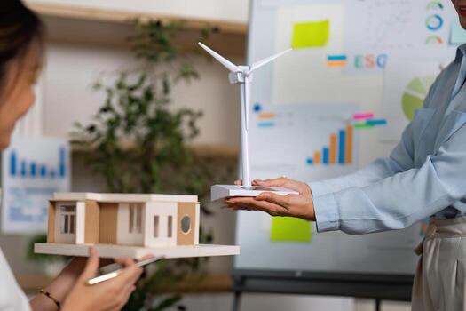 Sustainable Development. Team collaborating on ESG projects with models and data in office. photo