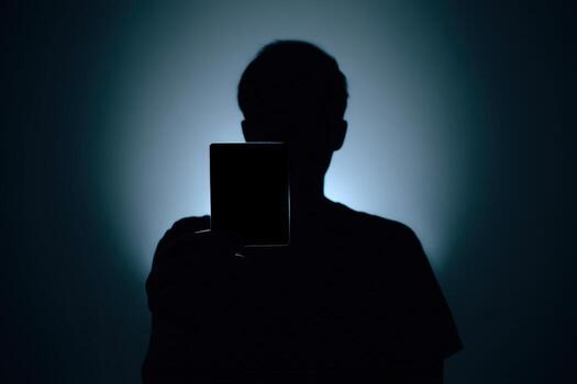 Mysterious silhouette holding an object in low light setting at night photo