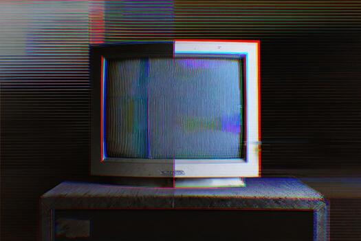 CRT monitor showing digital interference with static display in a dark room photo