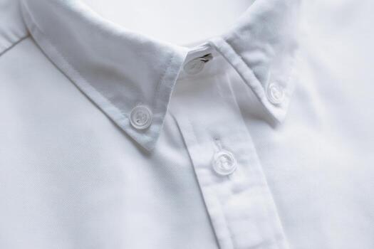 Shirt placket with hidden buttons displayed on white fabric surface photo