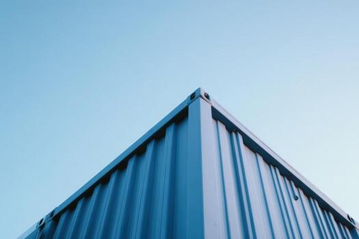 Blue container against clear sky at a construction site during daytime photo