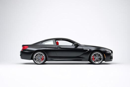 Matte black luxury car in side profile view against plain background photo