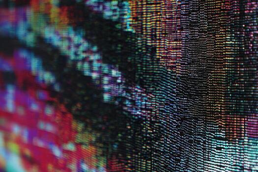Digital screen displaying partial pixel dropout with colorful patterns photo