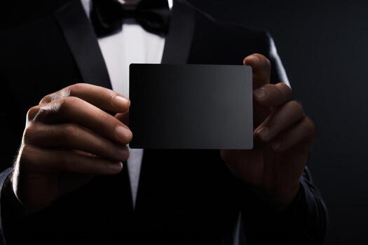 Elegant hands holding a sleek black card in a formal setting photo