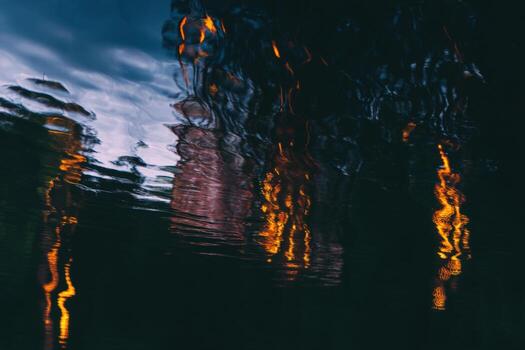 Striking reflection of colorful lights shimmering on calm water surface at dusk photo