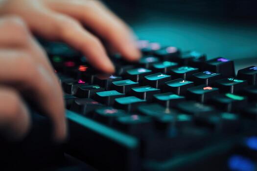 Fingers typing on a low-latency keyboard in a dimly lit space photo