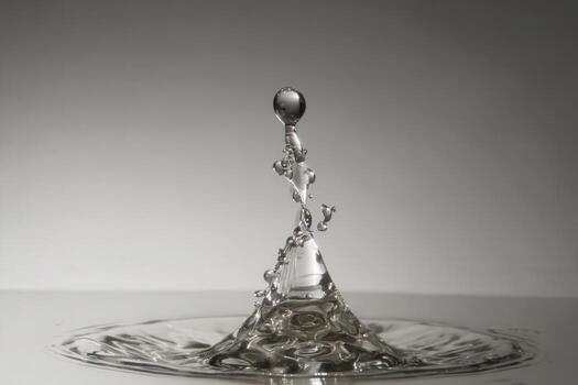 Water droplet bursts into multiple streams creating a beautiful splash effect photo