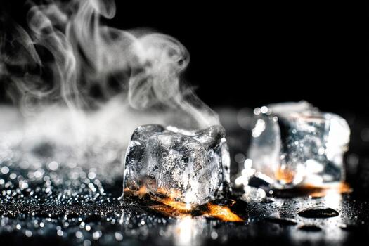 Melting ice cube on heated metal surface creates steam and condensation photo