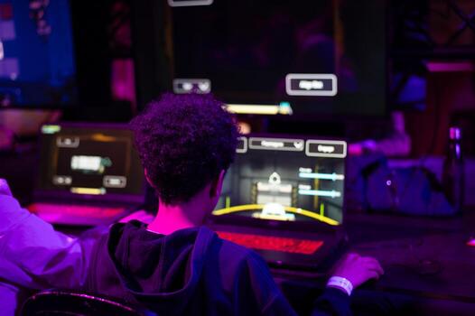 A young boy immersed in a computer game, showcasing modern technology and artificial intelligence in interactive entertainment and digital experiences. photo