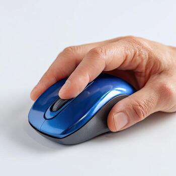 A person's hand holding a blue computer mouse photo