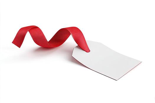 A white gift tag hangs from a red ribbon, curled in a graceful loop against a white backdrop photo